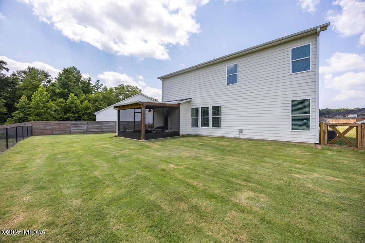 656 Dolly Drive Forsyth, GA 31029 - Photo 30 of 30 a backyard of a house with table and chairs
