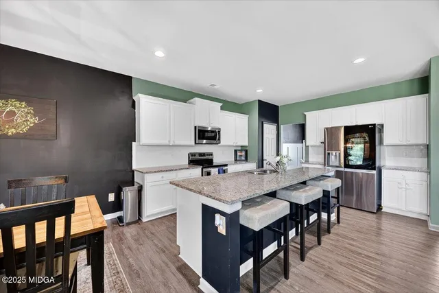 a view of kitchen with cabinets table and chairs