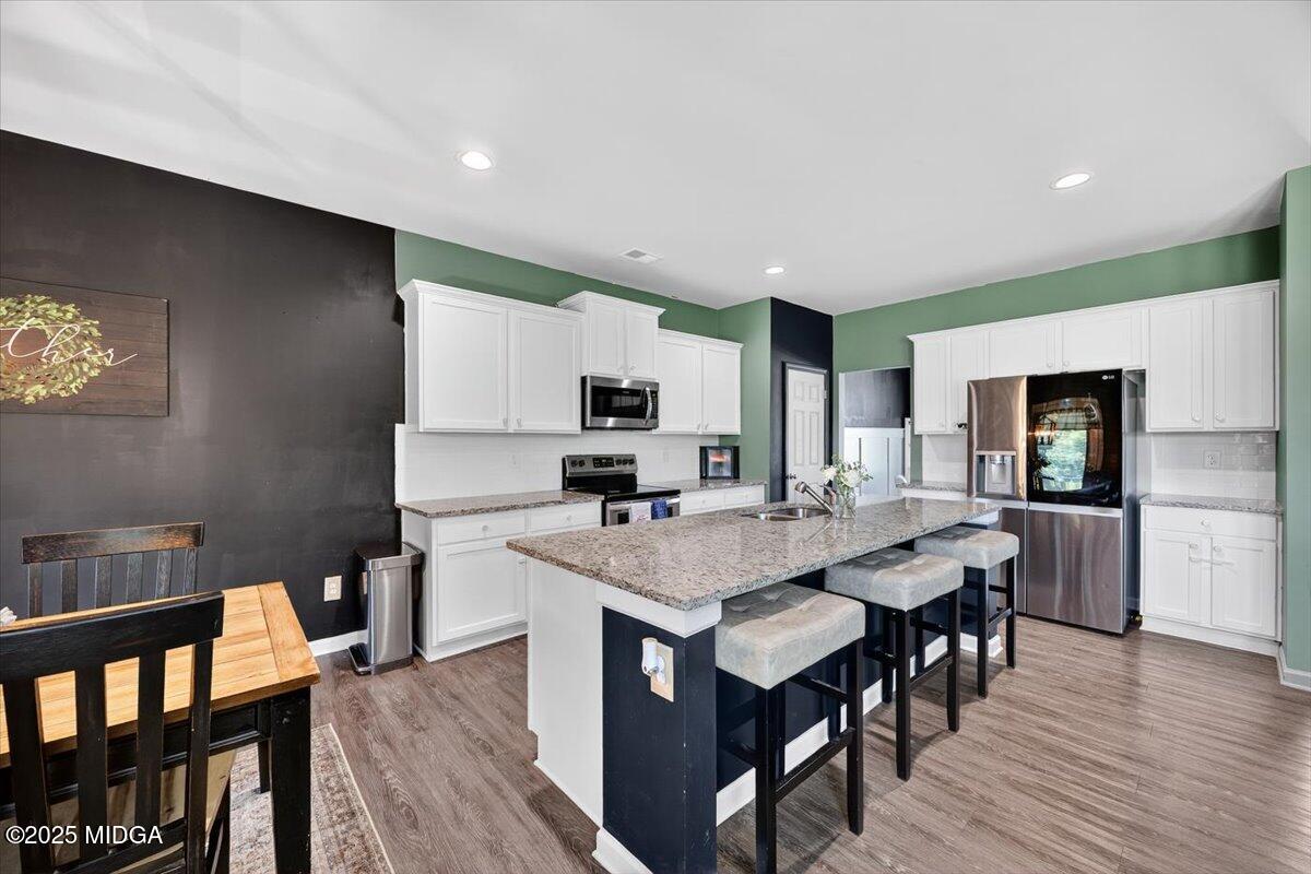 656 Dolly Drive Forsyth, GA 31029 - Photo 8 of 30 a view of kitchen with cabinets table and chairs