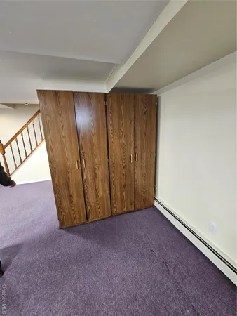 a bathroom with a toilet and a mirror