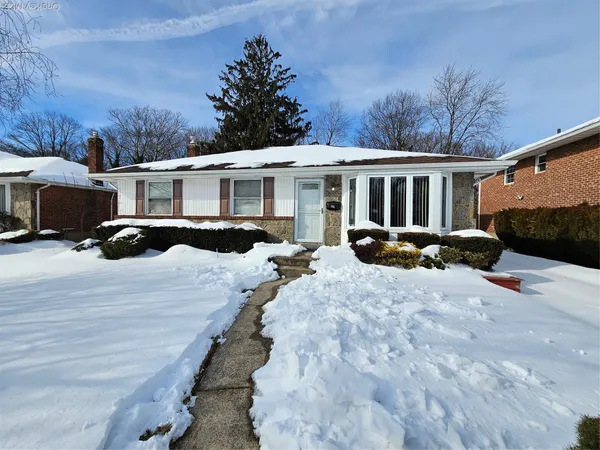 a view of a house with a yard covered with snow in front of house