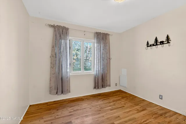 a view of a livingroom with wooden floor and closet