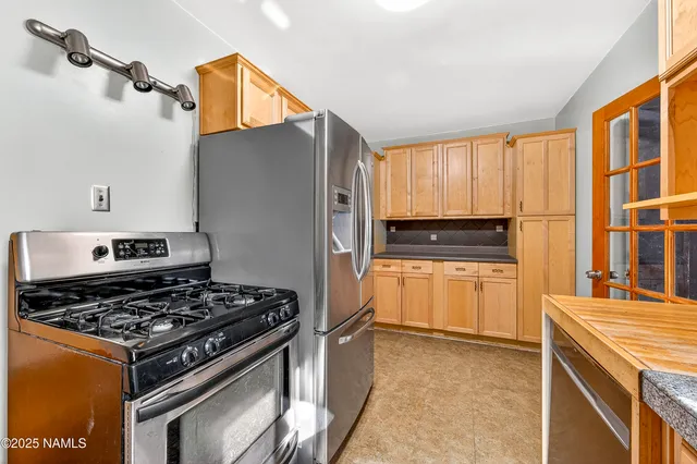 a kitchen with a stove and a refrigerator