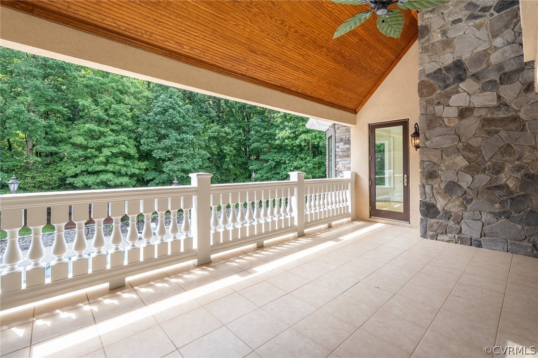 a view of a porch with wooden floor and fence