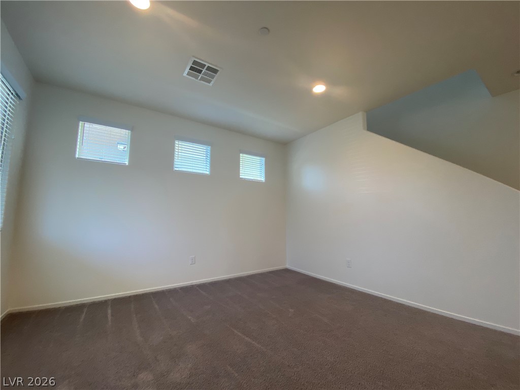 436 Cadence View Way Henderson, NV 89011 - Photo 11 of 36 An inviting room features recessed lighting and multiple windows with blinds, ideal for a flexible space.