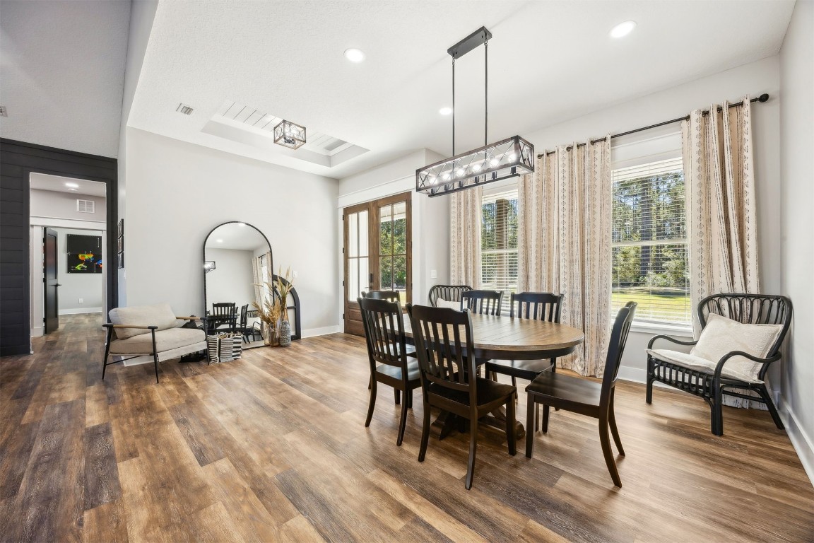 32500 Crossfire Trail Callahan, FL 32011 - Photo 15 of 64 a dining room with furniture a chandelier and wooden floor