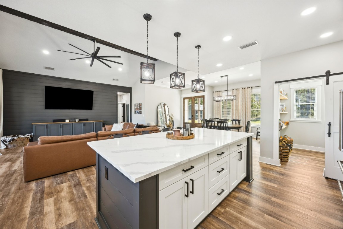32500 Crossfire Trail Callahan, FL 32011 - Photo 19 of 64 a large kitchen with kitchen island a sink appliances and wooden floor
