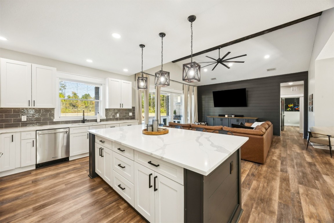32500 Crossfire Trail Callahan, FL 32011 - Photo 21 of 64 a large kitchen with kitchen island a stove a sink a center island and wooden floor