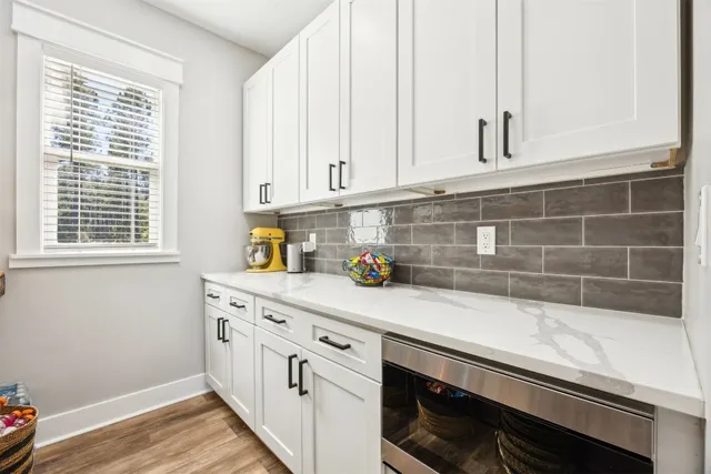 a kitchen with stainless steel appliances granite countertop a sink a stove and a refrigerator