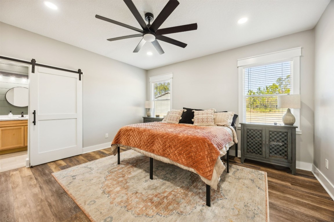 32500 Crossfire Trail Callahan, FL 32011 - Photo 25 of 64 a bedroom with a bed and a chandelier