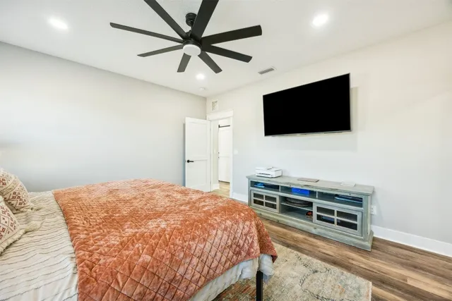 a bedroom with a bed and a chandelier