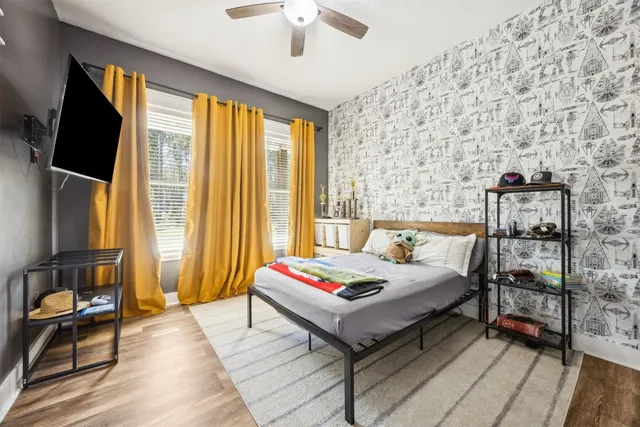 a bedroom with a bed and a flat screen tv