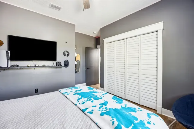 a bedroom with a bed and a flat screen tv