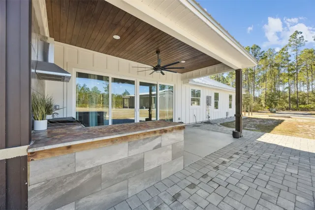 a view of a house with backyard and sitting area