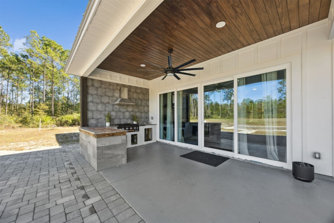 32500 Crossfire Trail Callahan, FL 32011 - Photo 39 of 64 a view of a patio with table and chairs and potted plants