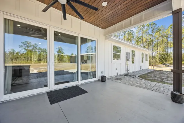 a view of a house with swimming pool and sitting area