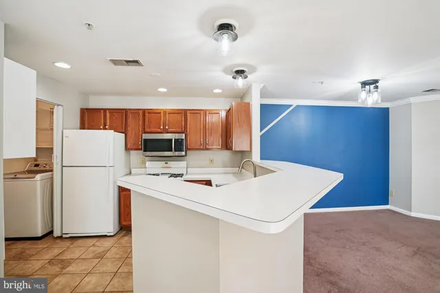 a kitchen with a refrigerator a stove and a sink