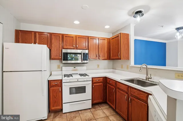 a kitchen with a white cabinets and white appliances