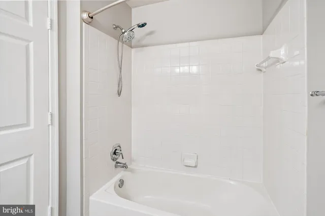 a white bath tub with a shower