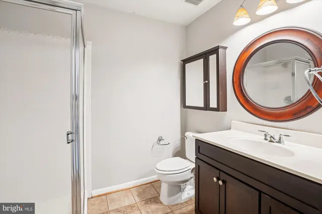 a bathroom with a toilet a sink and a mirror