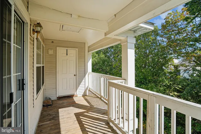 a view of a balcony with wooden floor