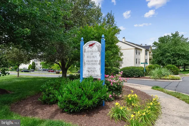 a front view of a house with a yard and fountain in middle