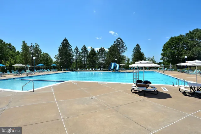 a view of a swimming pool and lounge chairs