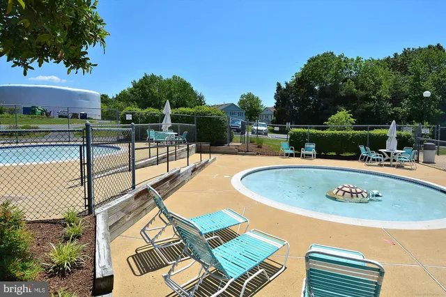 an outdoor space with pool and furniture