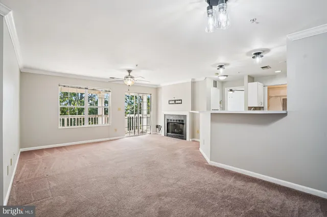 a view of a livingroom with an empty space and a fireplace