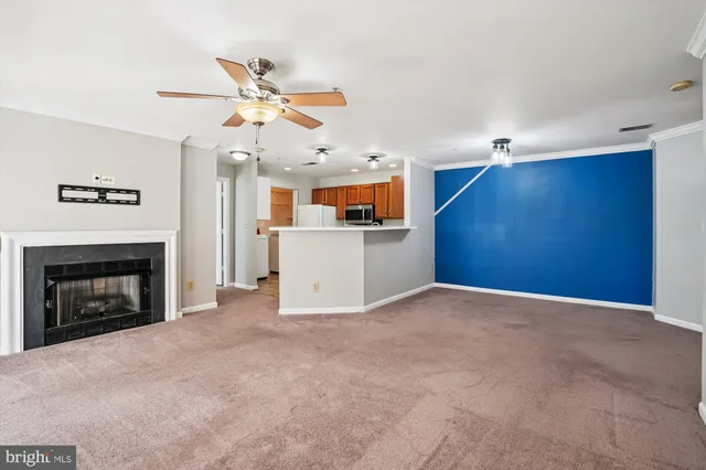 a view of a livingroom with a fireplace and a ceiling fan