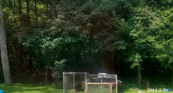 a wooden fence with trees in the background