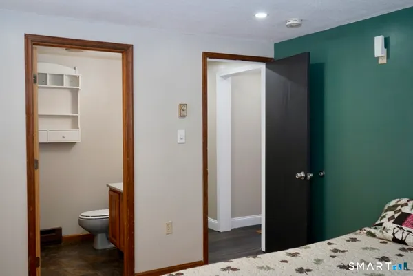 a bathroom with a sink a toilet and mirror