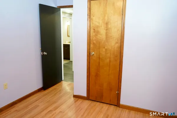 a view of a room with wooden floor and windows
