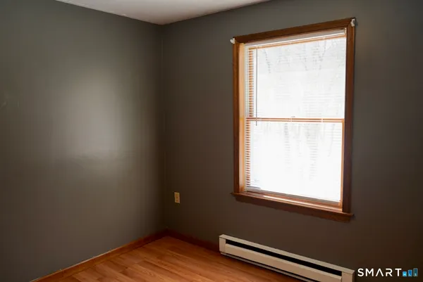 a white toilet sitting next to a shower curtain