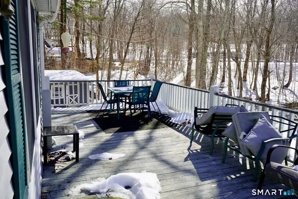a kitchen with stainless steel appliances white cabinets a wooden floor and a window