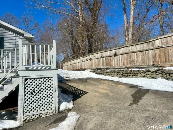 a view of a backyard with wooden fence