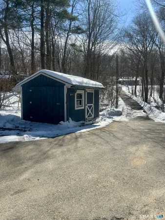a front view of a house with yard and trees