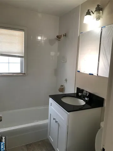 a bathroom with a sink a toilet and a bathtub