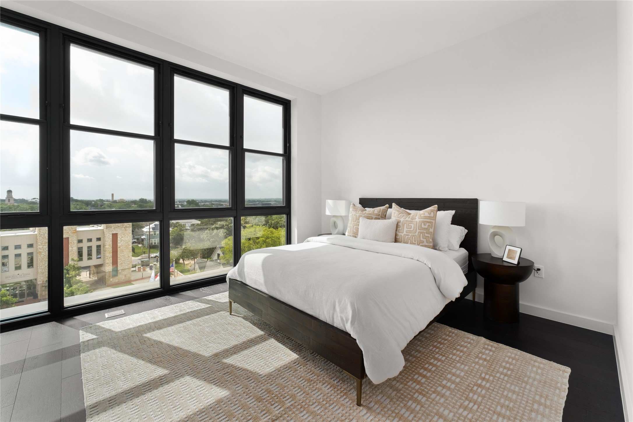 800 Embassy Drive, Unit 602 Austin, TX 78702 - Photo 6 of 37 a large bed sitting in a bedroom next to a large window