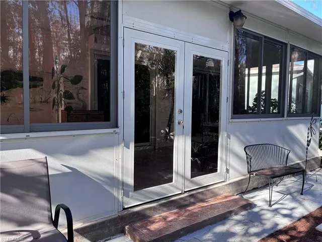 a view of a door with a chair and door