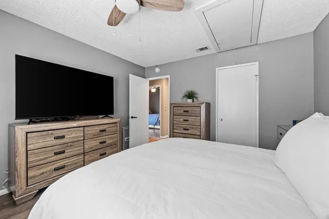 a bedroom with a bed and flat screen tv