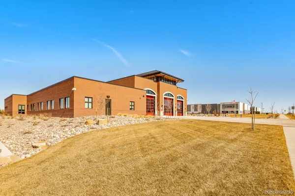 a front view of a building with sitting area