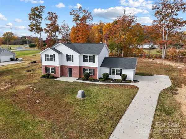 an aerial view of a house with a yard