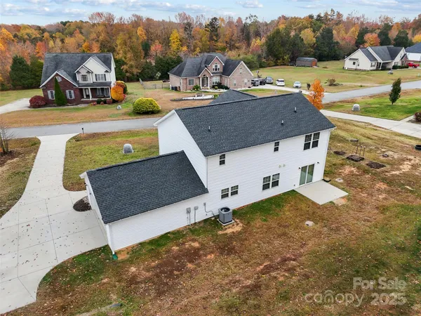 an aerial view of a house with yard swimming pool and lake view