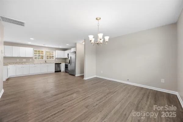 a view of a kitchen with a dishwasher cabinets and wooden floor