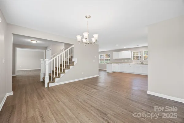 a view of a room with wooden floor and staircase