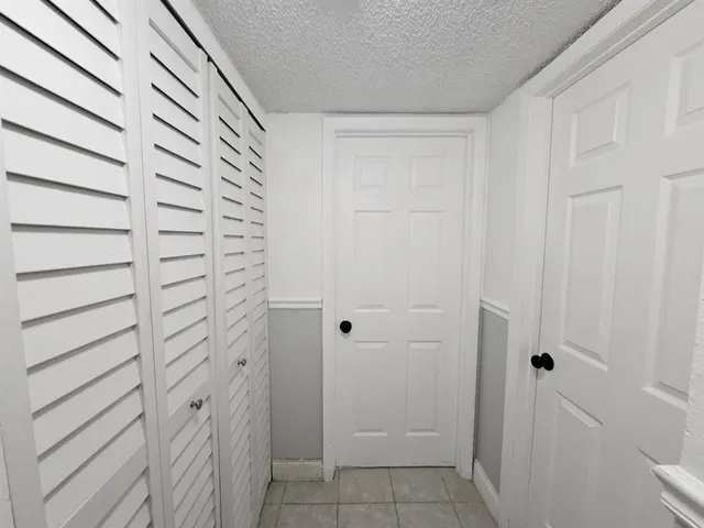 a bathroom with a bathtub sink vanity mirror and toilet