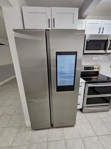 a kitchen with a refrigerator and a stove
