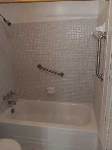 a bathroom with a toilet and shower