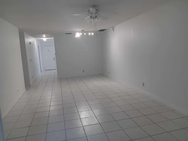 an empty room with white walls and tiles